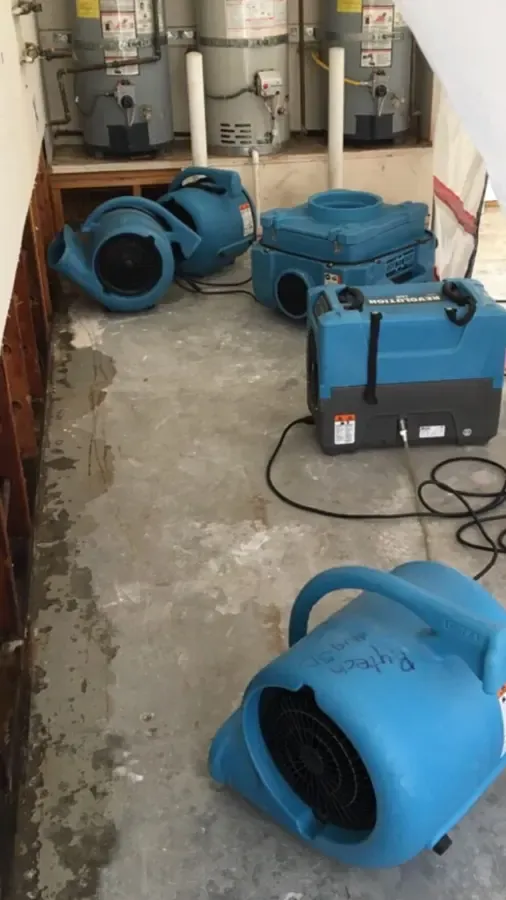 Air movers and dehumidifiers drying a room in Alpharetta, GA